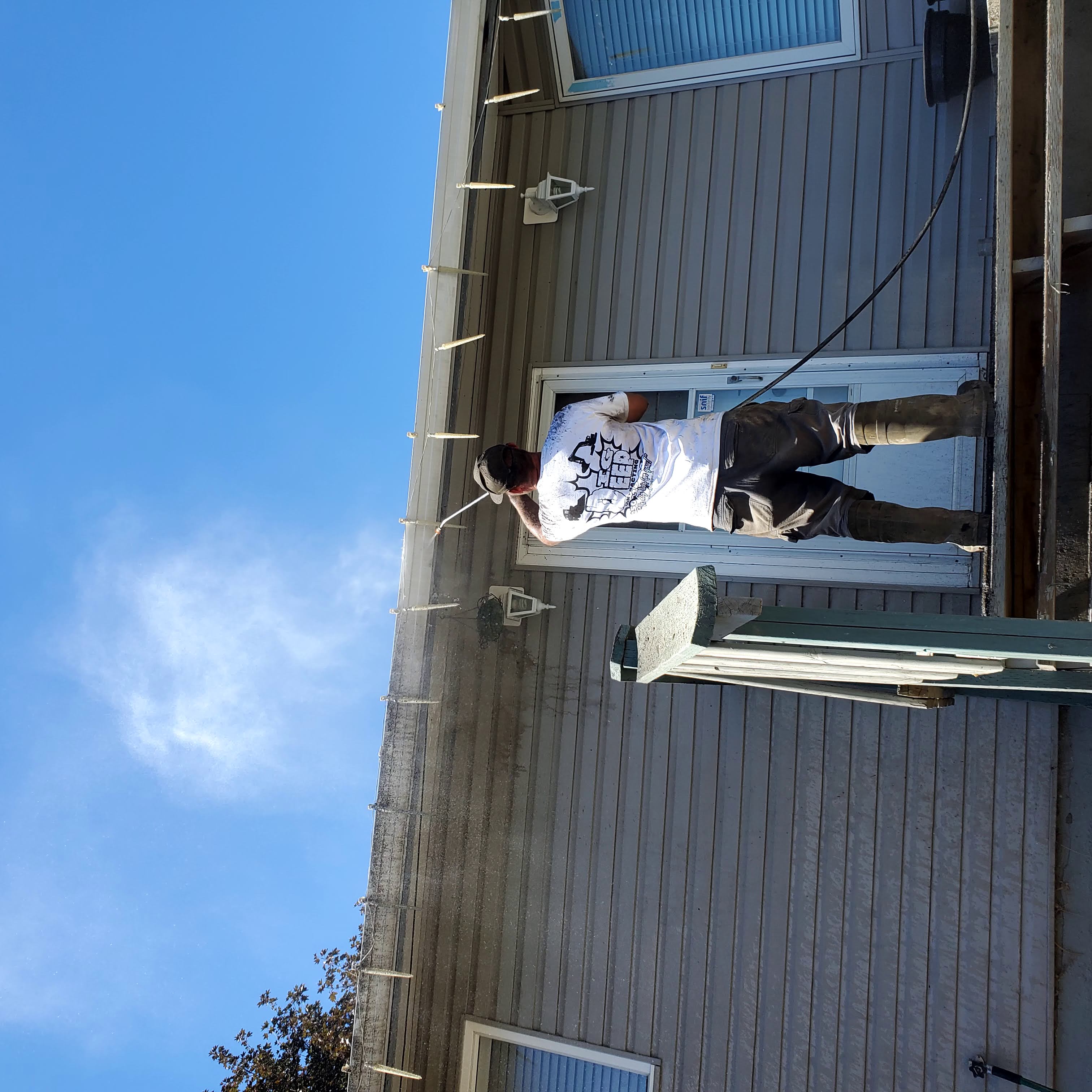 Power washing a house in Westsyde
